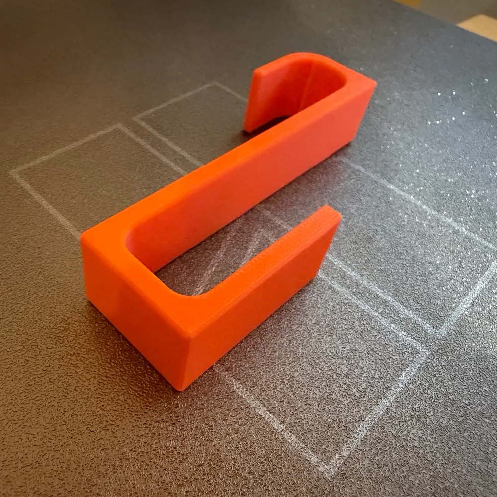 Ganxo per a tovalloles imprès en 3D, en taronja